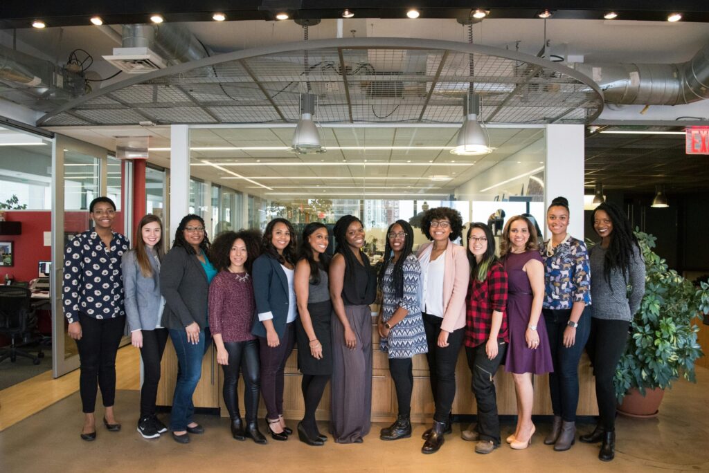 pexels-photo-1181438-1181438 A diverse group of women in technology poses together in an office lobby, exuding confidence and teamwork.